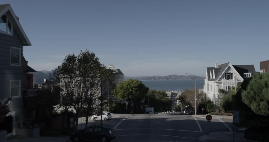Camera goes down suburban road as if in a car
