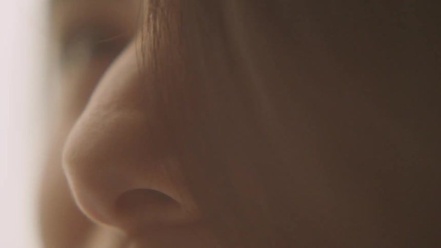 Closeup of a person's nose and hair with changing light