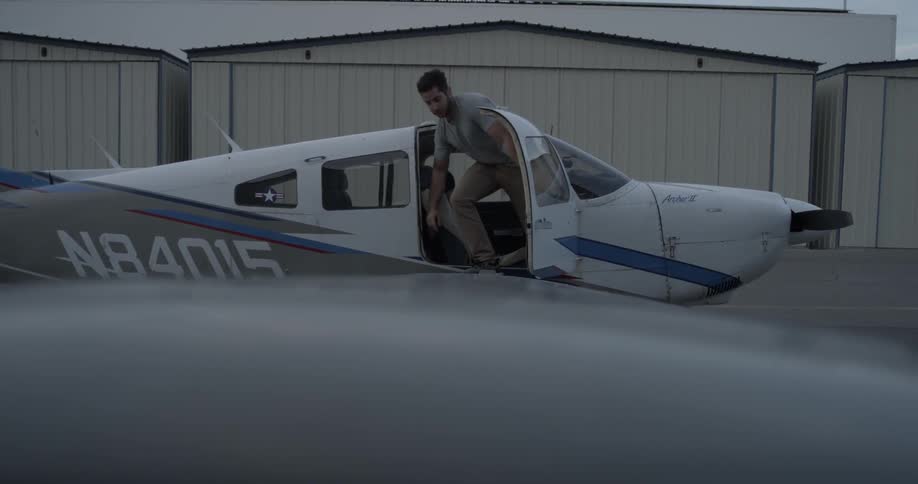 Man stepping out of small white plane