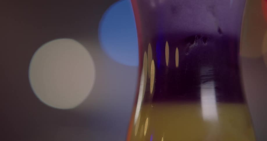A person is putting liquids into a glass