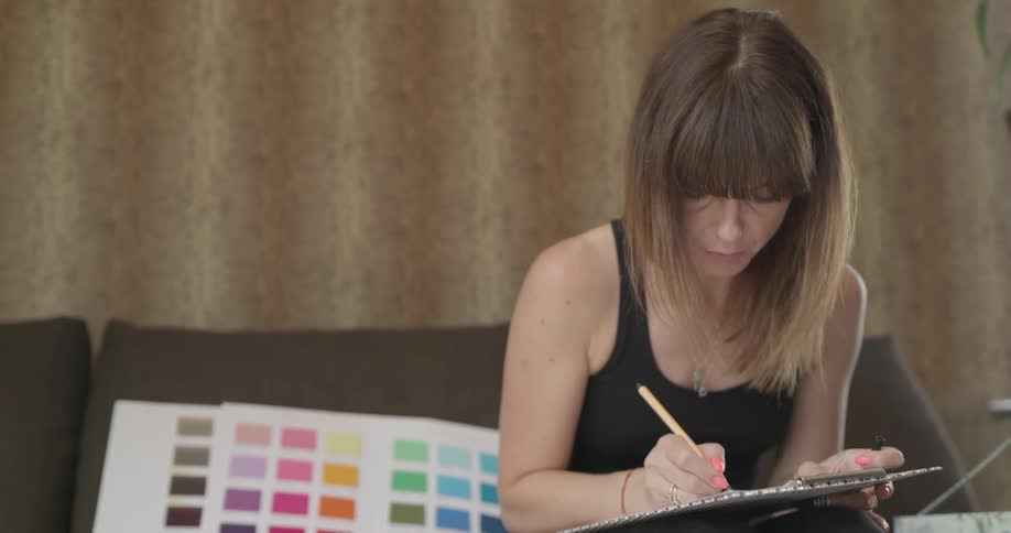 A woman is painting indoors