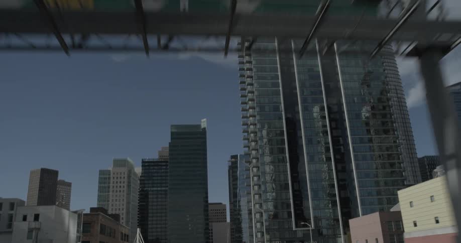 Driving on a freeway you see the large signs while approaching a large glass building