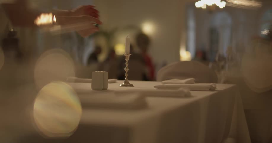 Candles are lit on a table