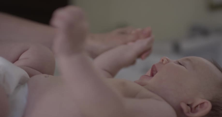 Person playing with a happy baby
