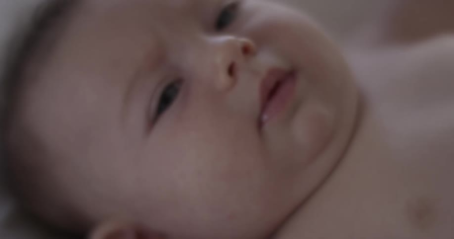 Baby with blue eyes looks into camera