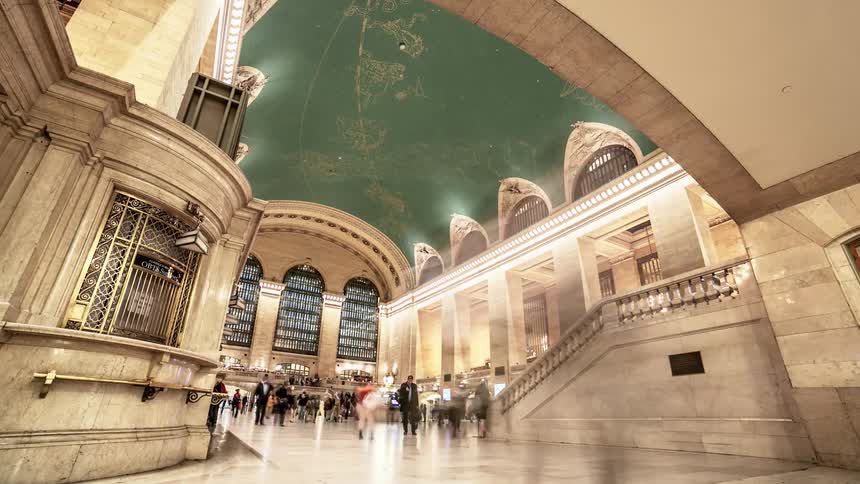 Many people come and go from a building with classic architecture