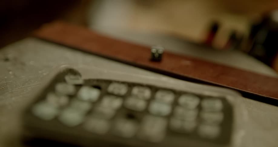 Leather smith punches holes in leather