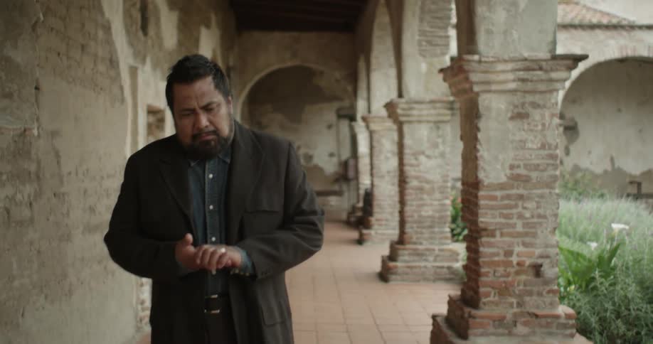 Despondent man removes his wedding band while walking outside