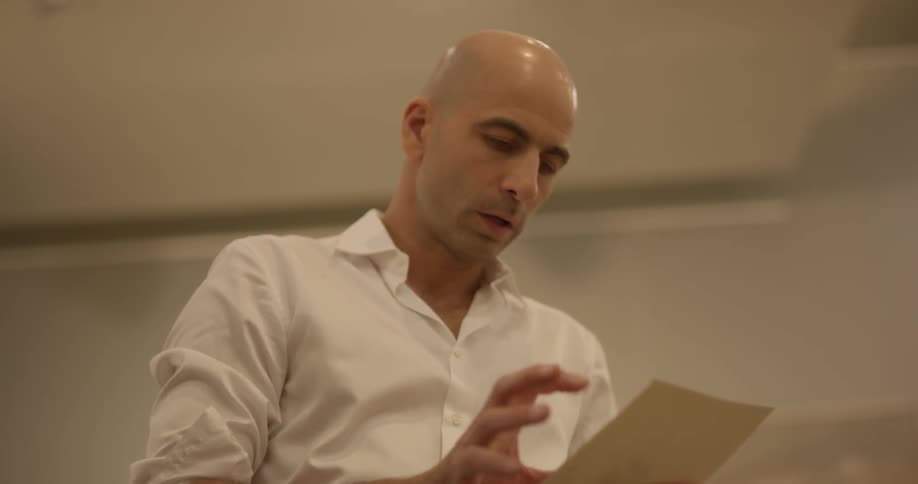 A man is looking at a piece of paper