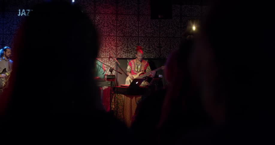 A group of people playing instruments on a stage
