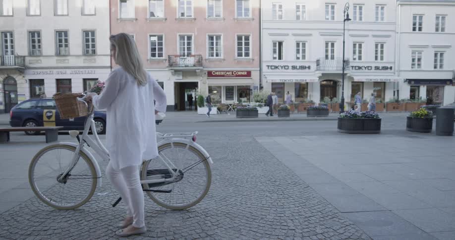 Woman Riding Bike To Coffee Shop