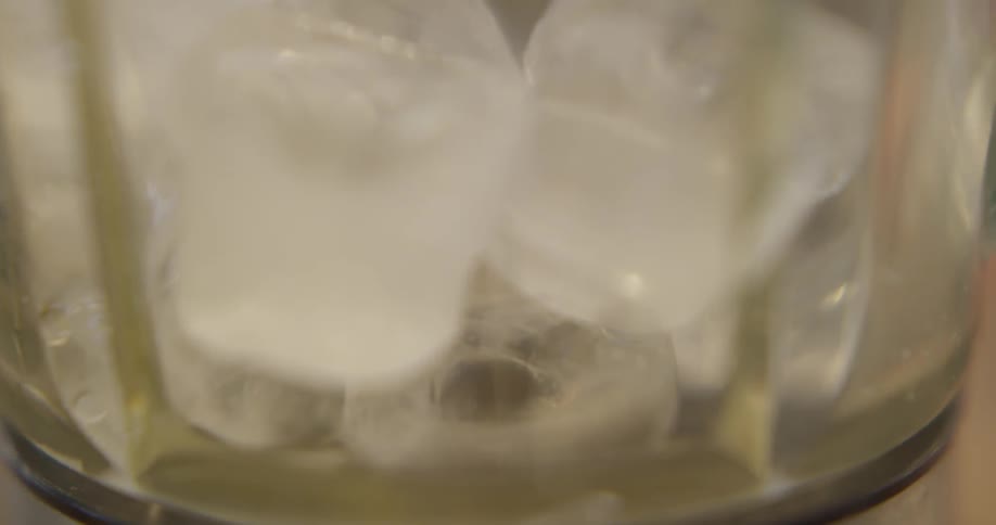 Ice is being placed into a cup