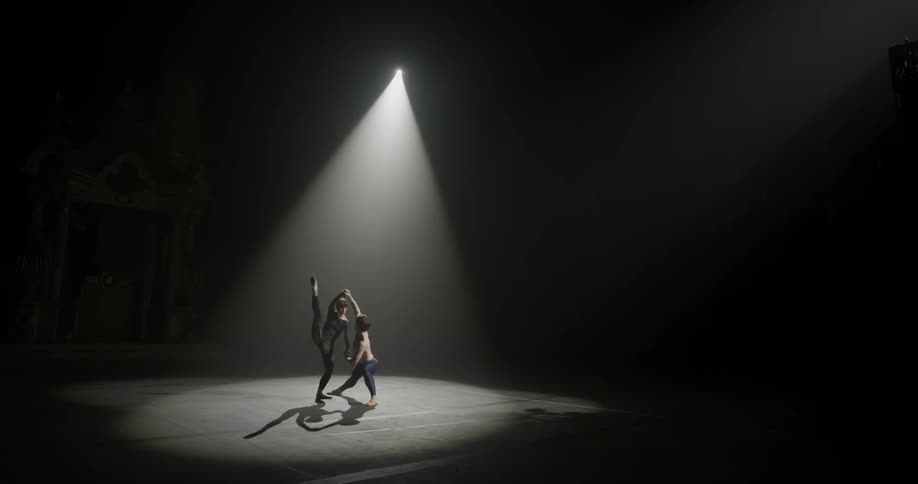 Two people are dancing together indoors