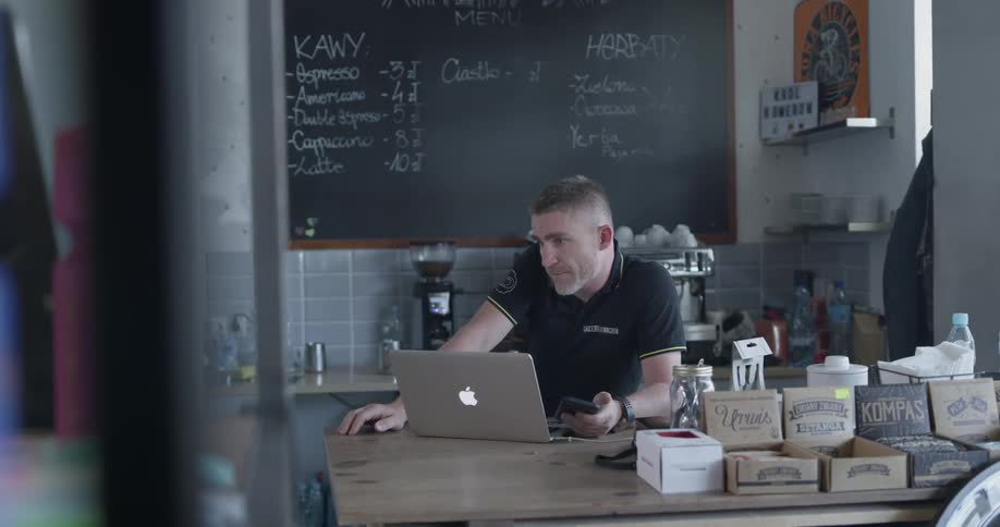 A man uses a laptop on a kitchen island