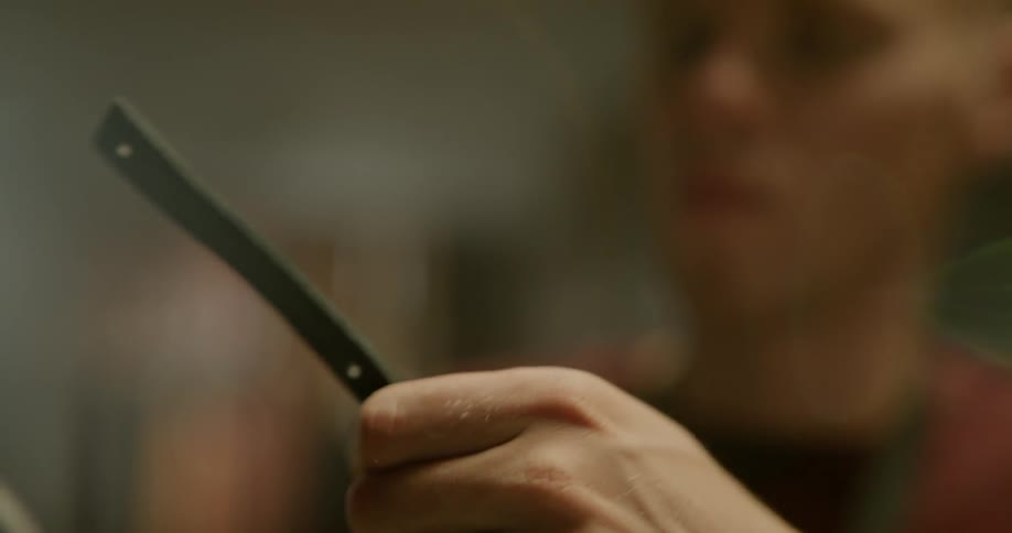 A person punches a whole and cuts something