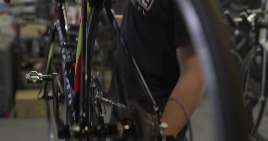 Man working on a bicycle in a repair shop