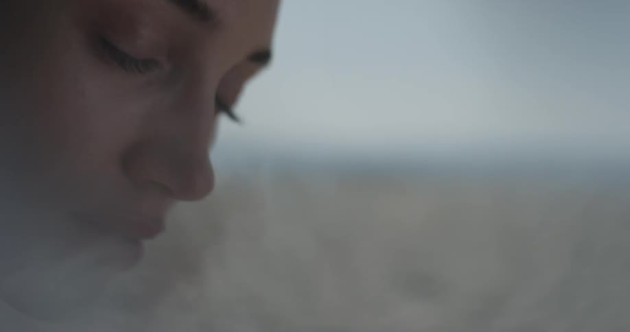 Woman looks into camera and then looks away