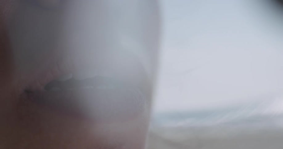 Close up of woman wearing lipstick parting lips