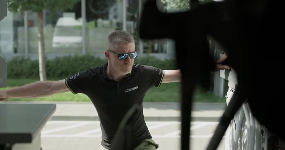 A man opens large back doors of a vehicle and steps inside