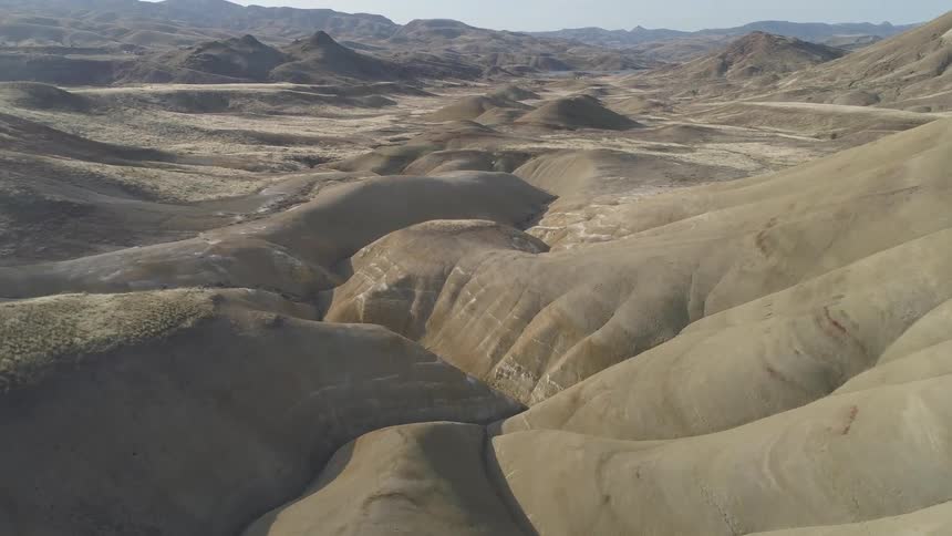 A mountain area that goes down into a valley