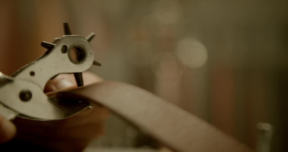 Hole punch is used on a leather belt
