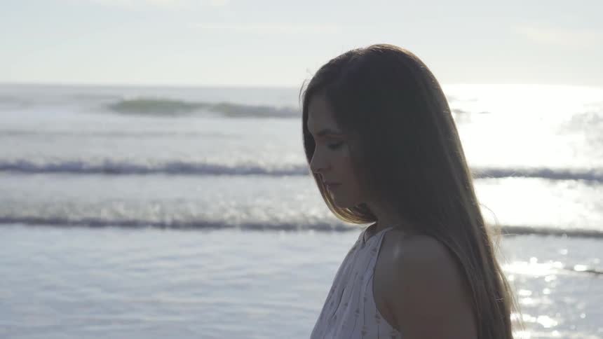 A woman walking along the beach