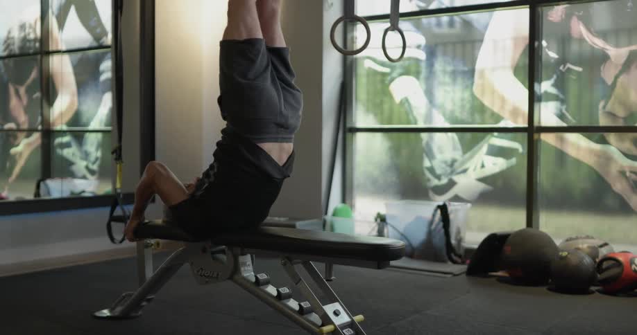 A man is stretching on work out equipment