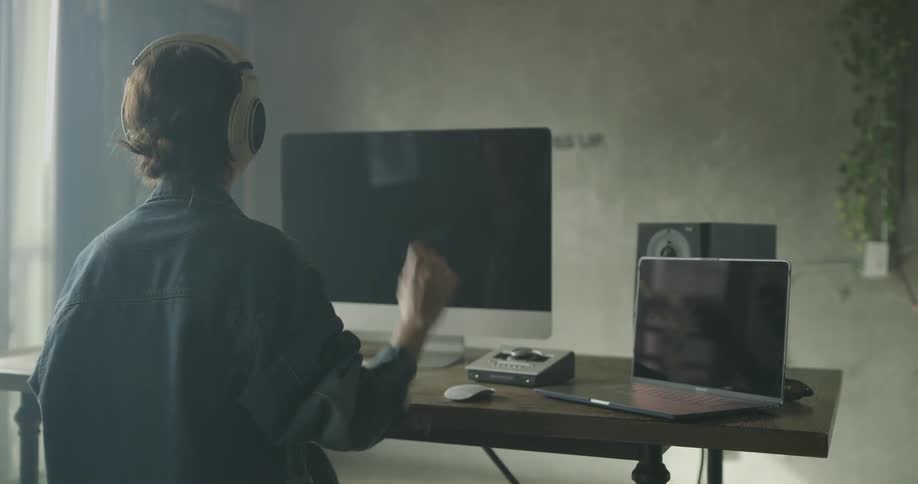Woman puts on headphones and nods her head