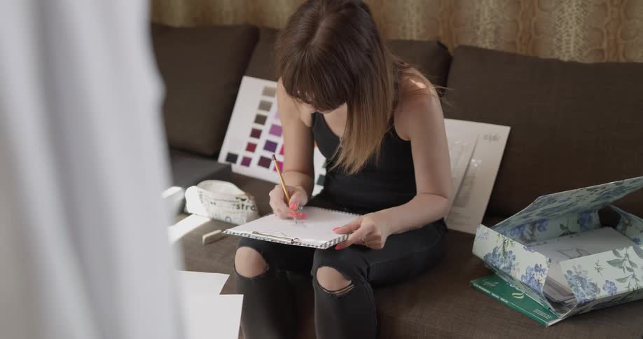 A woman is writing on a piece of paper