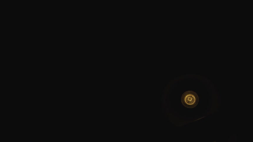 A light turns on above a railing then turns off the the filament remains on a bit