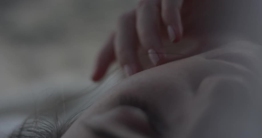 A woman is touching her face