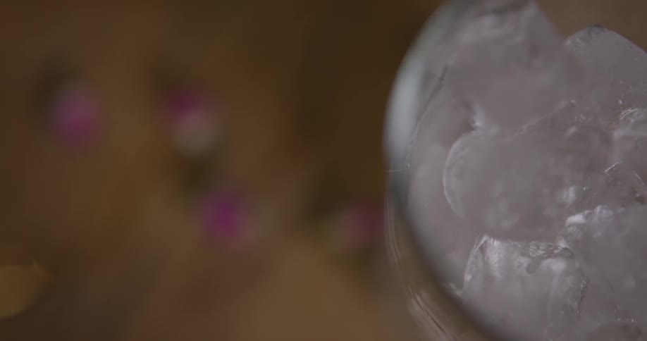 Ice cubes are poured into a glass