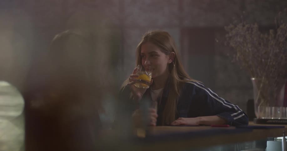 Two women talk while drinking at a table