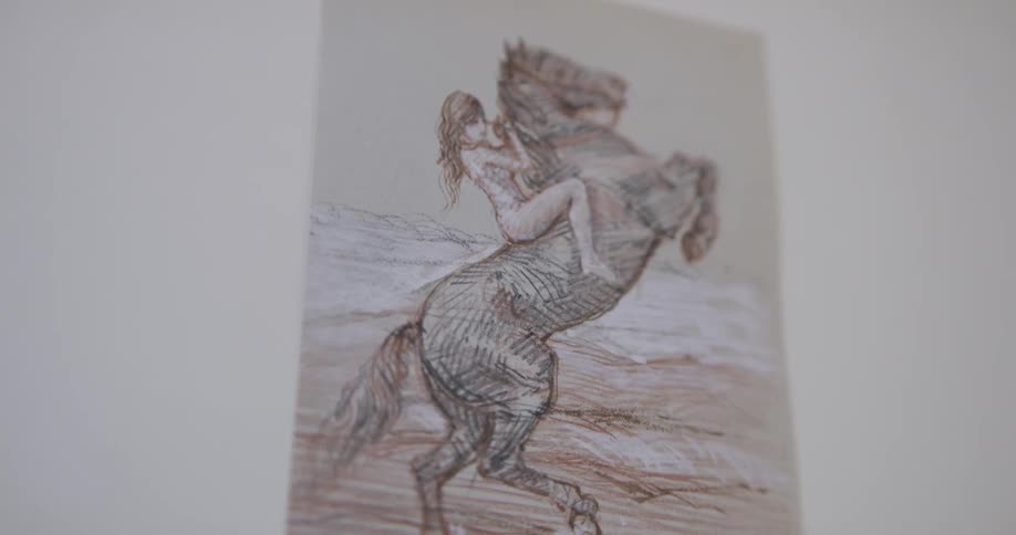 Drawing of woman riding rearing horse sits on wall