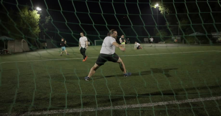A soccer player takes a shot at the goal