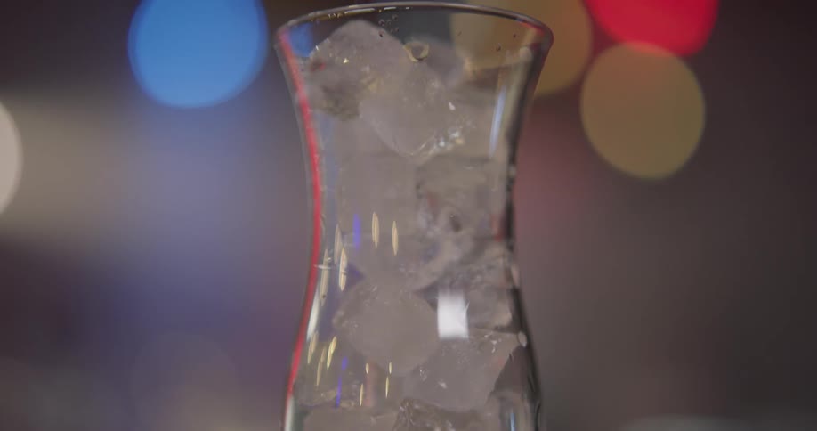 Ice is being poured into a cup