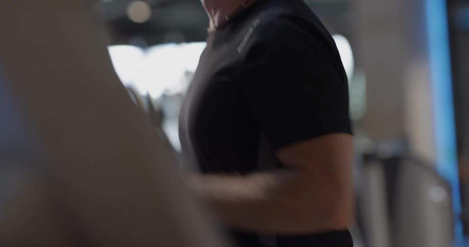 Man running on a treadmill in a gym
