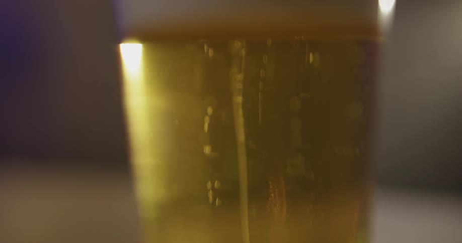 Bubbles are floating to the top of a glass