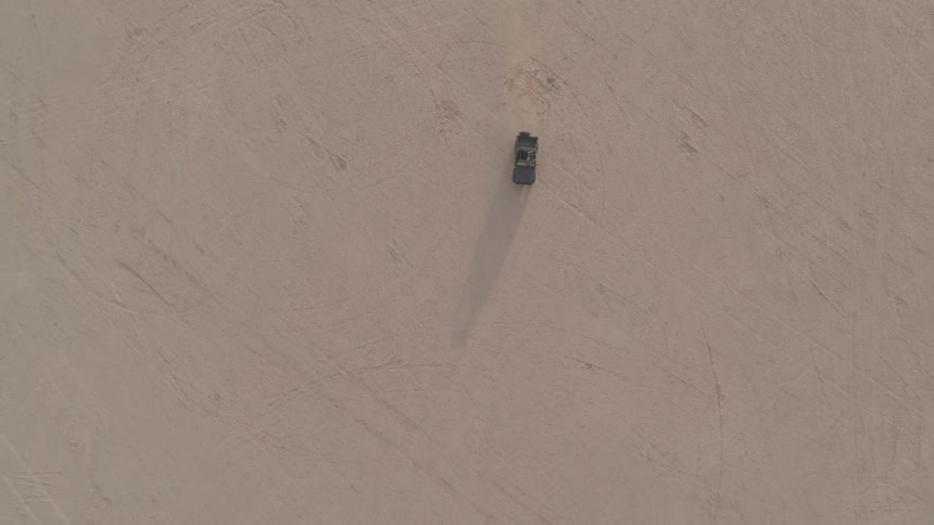 Person driving a vehicle in a dry dusty desert