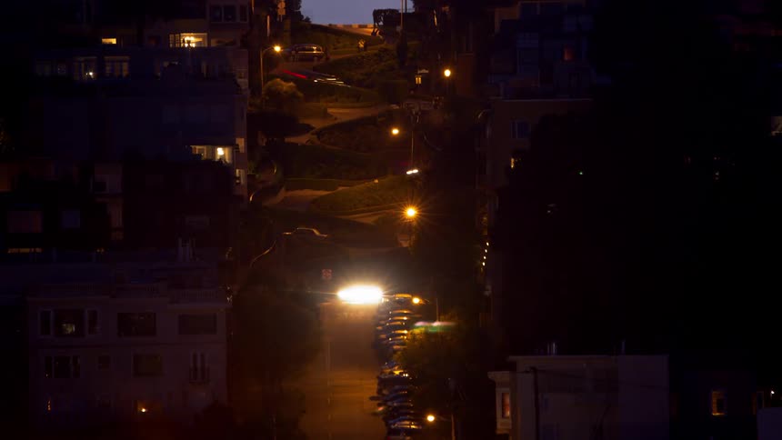 Very windy lombard street with vehicles driving on it
