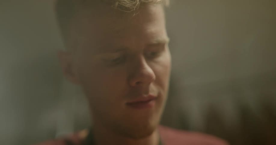 A man is looking down while standing