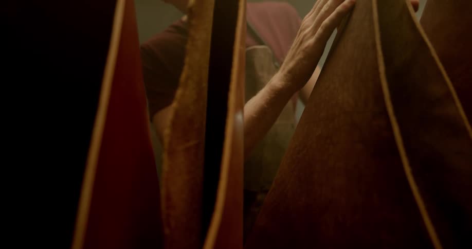 Man touching leather in leather shop