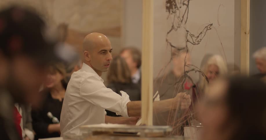 A person painting on a piece of plastic