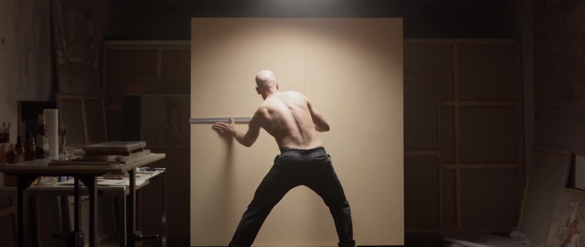 Man measures a large piece of canvas