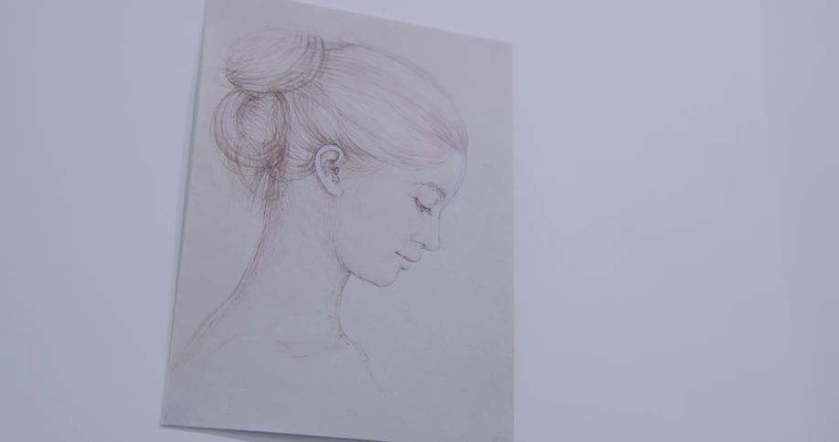 An artist drawing of a woman hanging on the wall