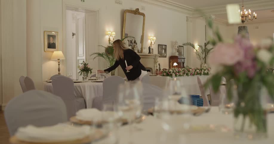 A woman puts candles at tables