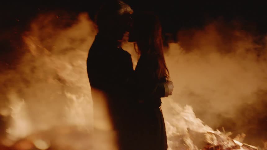 Couple Kissing By Fire In Desert