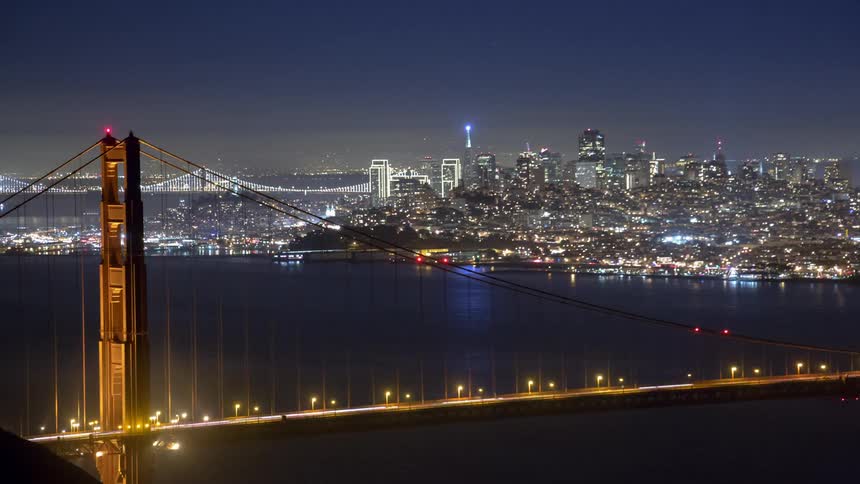 A stream of lights race across a bridge