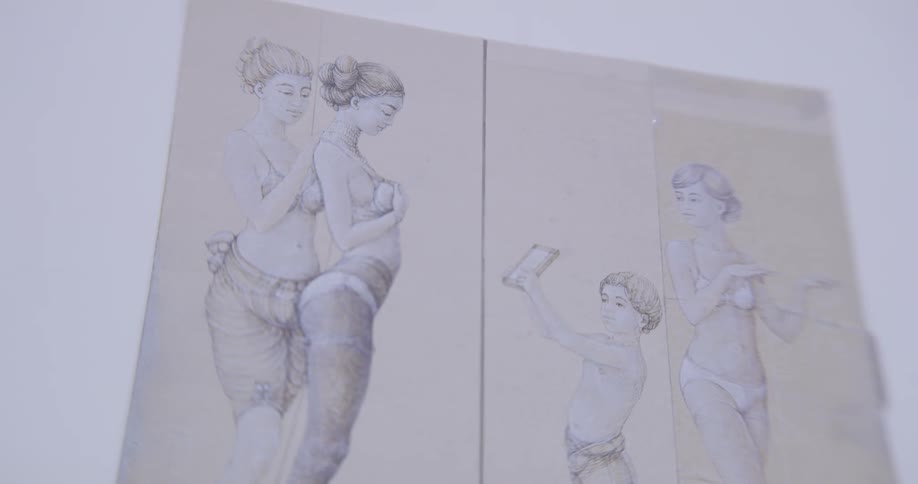 Sketches that are on canvas hanging in a room