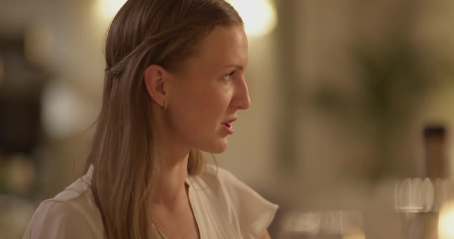 A woman at a table is talking and laughing